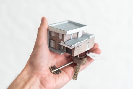 Small toy house in hands